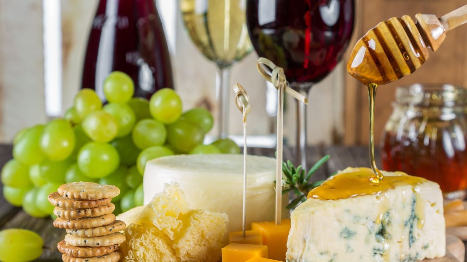 Tabla de quesos variados con curados, azul y frescos junto a copas de vino DO Utiel-Requena